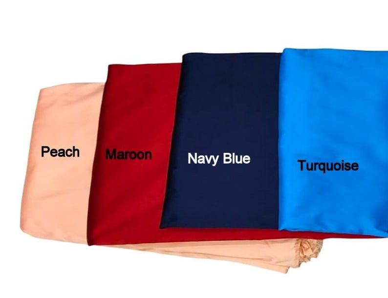 May include: Four fabric swatches in peach, maroon, navy blue, and turquoise. Each swatch has a label with its color name. The fabrics are folded and stacked, showcasing the different colors and textures.