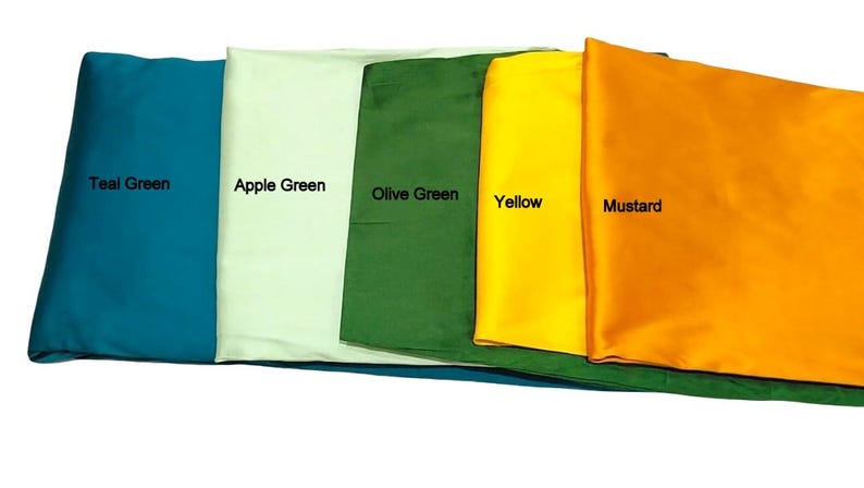 May include: A collection of folded fabric samples in various colors, including Teal Green, Apple Green, Olive Green, Yellow, and Mustard. Each sample is labeled with its respective color name in a clean, sans-serif font.