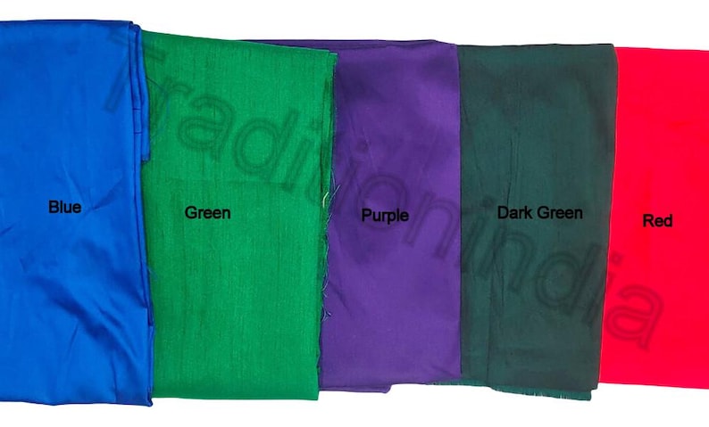 May include: Five fabric swatches in vibrant colors: blue, green, purple, dark green, and red. Each swatch is labeled with its respective color name in black text. The fabrics appear to be smooth and possibly silk or satin.