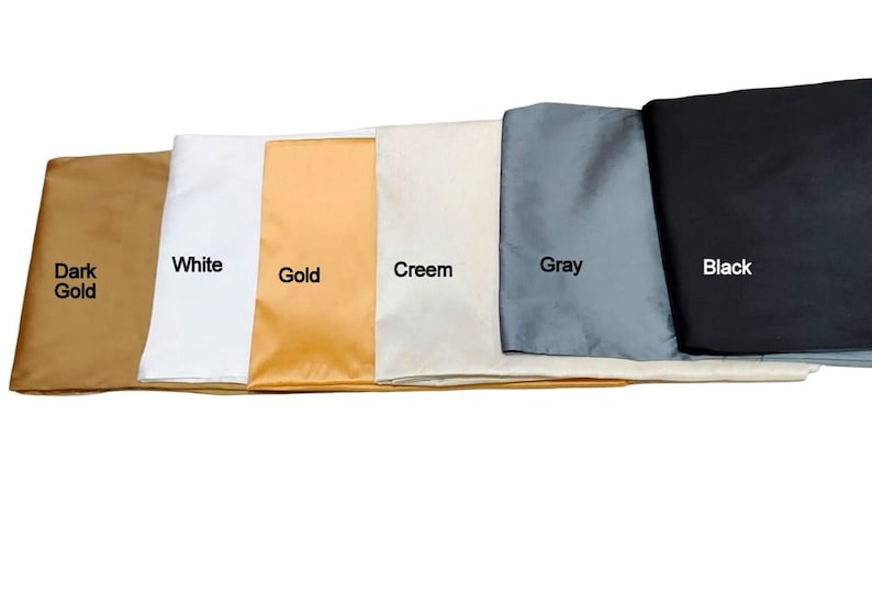 May include: A selection of fabric swatches in various colors, including dark gold, white, gold, cream, gray, and black. Each swatch is labeled with its respective color name in white text.