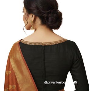 May include: Black long-sleeved blouse with gold trim around the neckline. The blouse is paired with a rust-colored sari with gold detailing. The image includes the text "@priyankasbo IN".