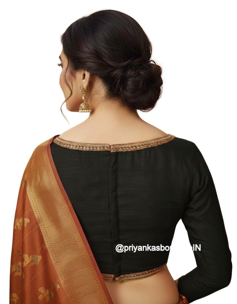 May include: Black long-sleeved blouse with gold trim around the neckline. The blouse is paired with a rust-colored sari with gold detailing. The image includes the text "@priyankasbo IN".