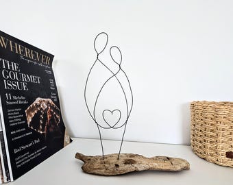 A Timeless Embrace: Wire Couple Sculpture on Coastal Driftwood