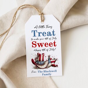 May include: A white gift tag with a brown string, featuring patriotic text and illustrations. The text reads "A little Texas Treat to make your 4th of July Sweet! Happy 4th of July!" with a cowboy hat and flag illustration. From: The Blackwell Family.