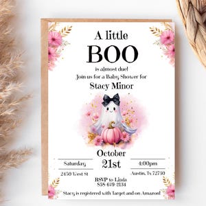May include: A pink and white baby shower invitation with a cute ghost holding a pumpkin. The invitation says "A little BOO is almost due!" and includes the date, time, and location of the shower. It also says "Stacy is registered with Target and on Amazon!"