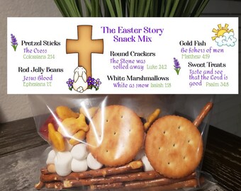 May include: A clear plastic bag filled with a snack mix for Easter. The bag has a label that says "The Easter Story Snack Mix" and lists the different snacks and their corresponding Bible verses. The snacks include pretzel sticks, red jelly beans, round crackers, white marshmallows, and gold fish crackers.