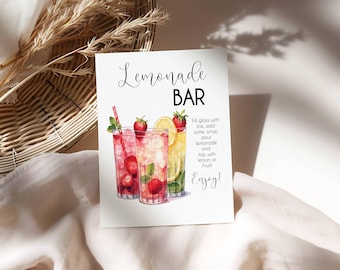 May include: A white sign with the words "Lemonade BAR" in elegant script. The sign features watercolor illustrations of lemonade drinks with strawberries and lemons. Instructions are included: "Fill glass with ice, add some syrup, pour lemonade and top with lemon or fruit! Enjoy!"