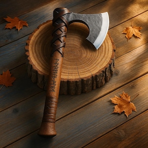 May include: A handcrafted axe with a wooden handle wrapped in brown leather. The axe head is made of steel. The handle has engraved runes. The axe rests on a wooden tree slice, with autumn leaves scattered around.