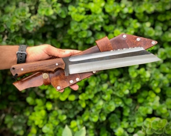May include: A brown leather sheath with a silver metal knife with a wooden handle. The knife is sharp and has a curved blade.
