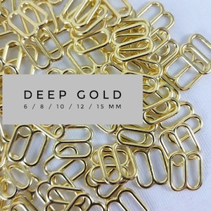 Puede incluir: Un montón de hebillas deslizantes de metal de color dorado en varios tamaños, incluyendo 6 mm, 8 mm, 10 mm, 12 mm y 15 mm. El texto "DEEP GOLD" y "6 / 8 / 10 / 12 / 15 MM" está impreso en una etiqueta blanca.
