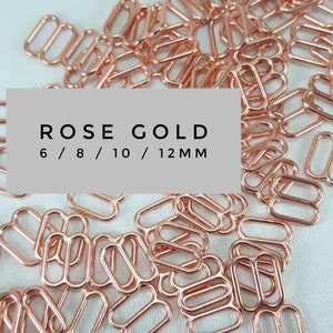 Könnte beinhalten: Ein Haufen roségoldener Metall-Schieberverschlüsse in verschiedenen Größen, 6 mm, 8 mm, 10 mm und 12 mm. Diese sind ideal für die Herstellung von Schmuck, Taschen und anderen Bastelarbeiten.