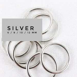 May include: A set of silver jump rings in various sizes, 6mm, 8mm, 10mm, and 12mm. These rings are perfect for jewelry making and crafting.