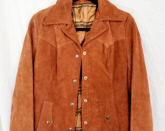May include: A brown suede jacket with a button closure and two pockets. The jacket has a plaid lining.