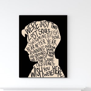 May include: Black and white typography art print with a silhouette of a person's head. The text reads "We were just two lost souls swimming in a fish bowl year after year running over the same old ground & what we found? Have the same old fears. Wish you were here."