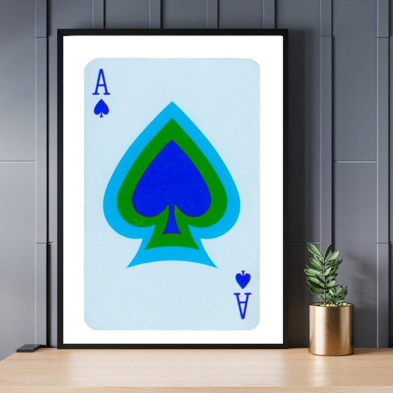 May include: A framed print of a playing card, the Ace of Spades, with a blue, green, and black spade design on a light blue background.