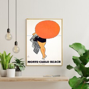 May include: A vintage travel poster advertising Monte-Carlo Beach. The poster features a woman in a black and white striped swimsuit holding a large orange umbrella.
