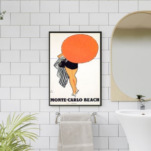 May include: A vintage poster featuring a woman in a black and white striped swimsuit holding a bright orange umbrella. The poster has the text "Monte-Carlo Beach" in black letters.