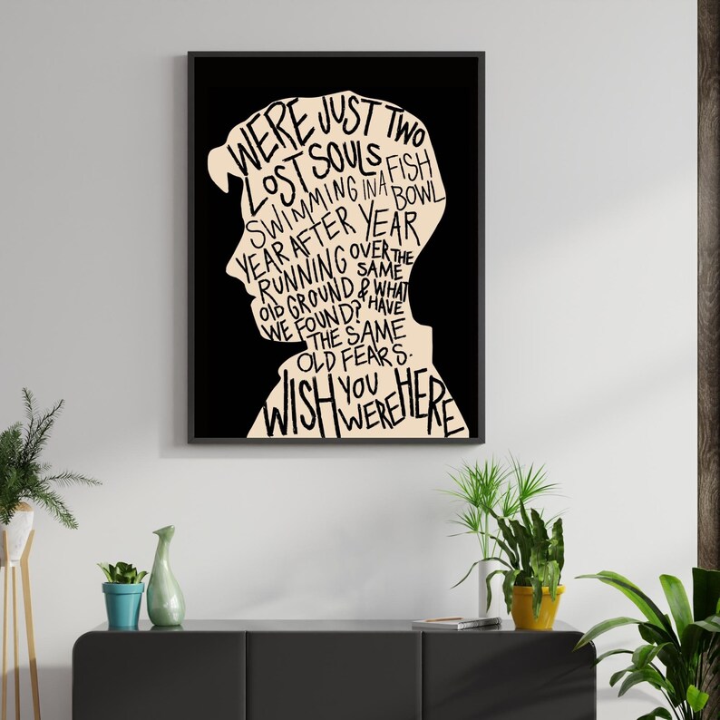 May include: Black and white typography art print with a silhouette of a person's head. The text reads "We were just two lost souls swimming in a fish bowl year after year running over the old ground & what we found? Have the same old fears. Wish you were here."