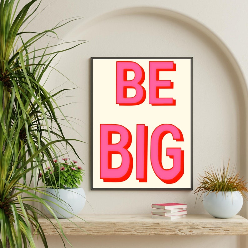 May include: A framed print with a white background and red outline. The print says "BE BIG" in large, pink letters.