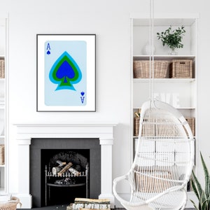 May include: A framed print of a playing card, the Ace of Spades, with a blue, green, and black spade design on a light blue background.