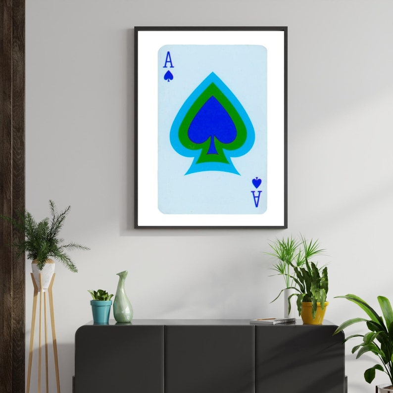 May include: A framed print of a playing card, the Ace of Spades, with a blue, green, and white spade design on a light blue background.