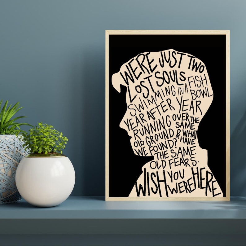 May include: Black and white typography art print with a silhouette of a person's head. The text reads "We were just two lost souls swimming in a fish bowl year after year running over the old ground & what we found? Have the same old fears. Wish you were here."