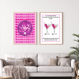 May include: Two pink framed prints with white text and illustrations. The left print features a disco ball and the text "Wanna Disco?" repeated multiple times. The right print features two martini glasses with olives and the text "Get us two Absolut Martinis in seven-and-a-half minutes, you will bring us two more. Then two more every five minutes after that, until one of us passes the f*ck out."