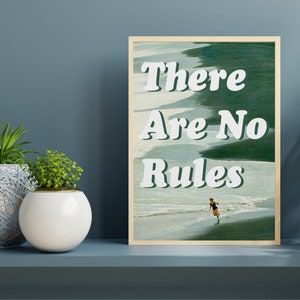 May include: A framed print with a green and blue beach scene and the text "There Are No Rules" in white. A person is running on the beach.
