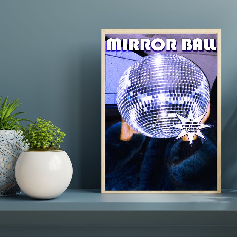 May include: A poster with the text "MIRROR BALL" in large, colorful letters. A person is holding a large silver disco ball in front of their face. The text "I'LL SHOW YOU EVERY VERSION OF YOURSELF TONIGHT!" is in a starburst shape.