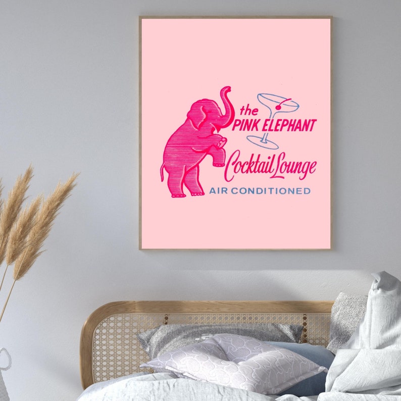 May include: A pink elephant illustration with a martini glass above it. The text reads "the PINK ELEPHANT Cocktail Lounge AIR CONDITIONED".