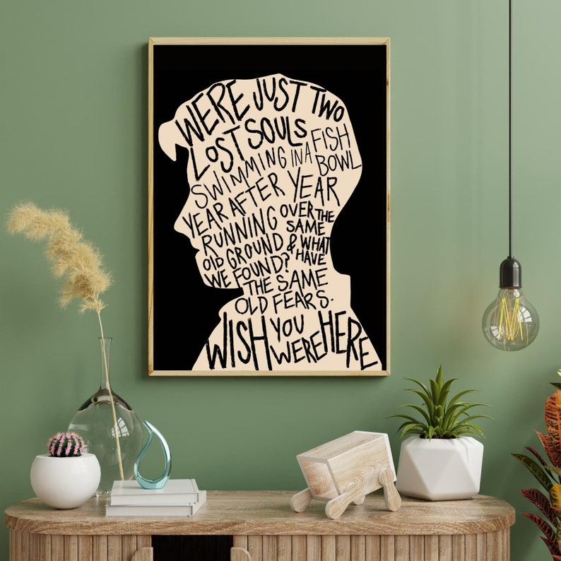 May include: Black and white typography art print featuring a silhouette of a person with the words "We were just two lost souls swimming in a fish bowl year after year running over the same old ground & what we found? Have the same old fears. Wish you were here."