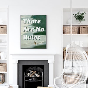 May include: A framed print with the text "There Are No Rules" in white letters on a green and blue background. The print features a person running on a beach.
