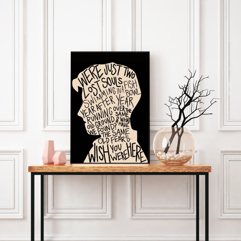 May include: Black and white typography art print with the text "WERE JUST TWO LOST SOULS SWIMMING IN A FISH BOWL YEAR AFTER YEAR RUNNING OVER THE OLD GROUND & WHAT WE FOUND? HAVE THE SAME OLD FEARS. WISH YOU WERE HERE"