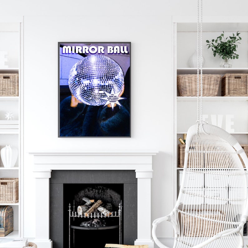 May include: A poster with the text "Mirror Ball" in a purple and blue gradient. The poster features a person with a disco ball covering their face. The disco ball is silver and has a starburst effect around it. The text "I'll show you every version of myself, tonight" is in a white speech bubble.