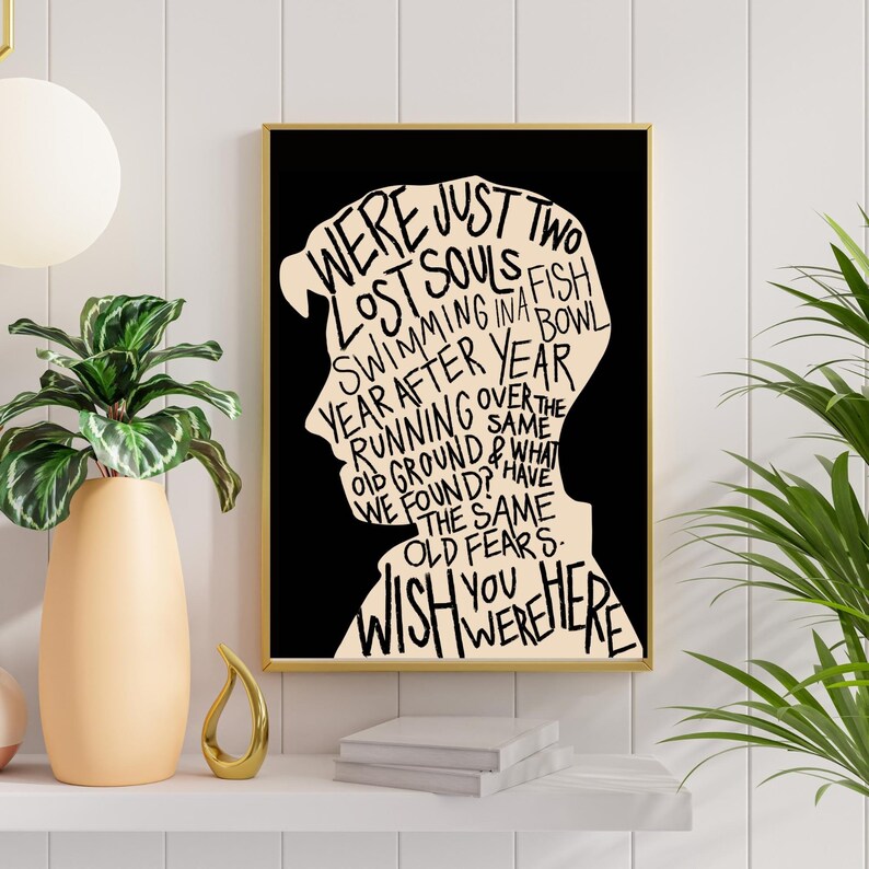 May include: Black and white typography art print with a silhouette of a person's head. The text reads "Were just two lost souls fish swimming in a year after year running over the old ground & what we found? Have the same old fears. Wish you were here."