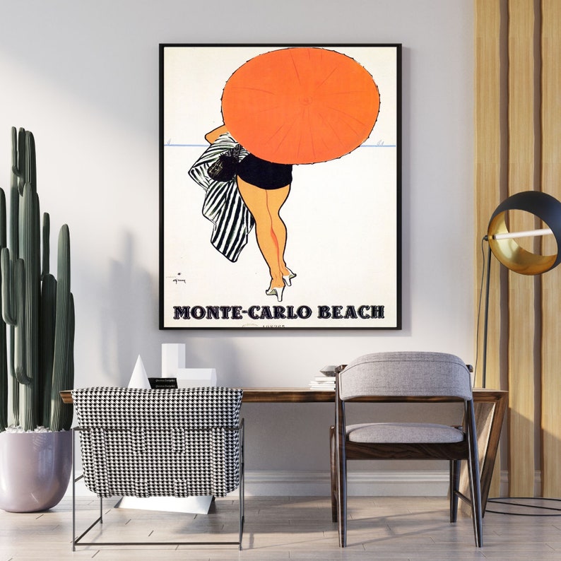 May include: A vintage travel poster featuring a woman in a black and white striped swimsuit walking away from the camera on a beach. She is holding a large orange umbrella. The text "Monte-Carlo Beach" is printed in black at the bottom of the poster.