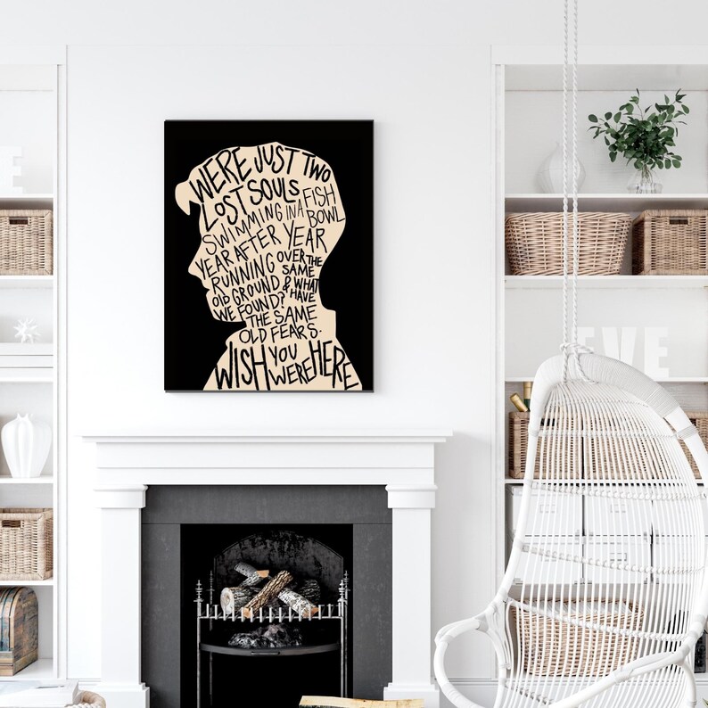 May include: Black and white typography art print with a silhouette of a person's head. The text reads "We were just two lost souls swimming in a fish bowl year after year running over the same old ground & what we found? Have the same old fears. Wish you were here."