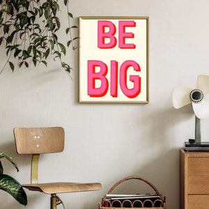 May include: A framed print with a white background and the words "BE BIG" in pink letters.