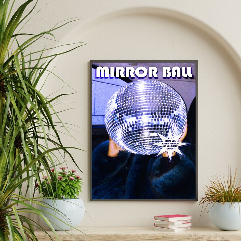 May include: A poster with the text "MIRROR BALL" in bold white letters on a black background. A person is holding a large silver disco ball in front of their face. The text "I'LL SHOW YOU EVERY VERSION OF YOURSELF TONIGHT!" is in a white starburst shape.