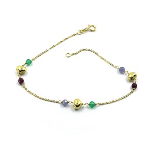 May include: A gold chain bracelet with small heart charms and green, purple and blue beads.