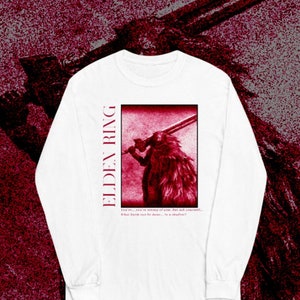 May include: White long-sleeve t-shirt with a red graphic of a character from the video game Elden Ring. The graphic features a character holding a sword and the text "ELDEN RING". The text below the graphic reads "I see me... you are yearning of some... but not yourself... What harm can be done... to a shadow?"