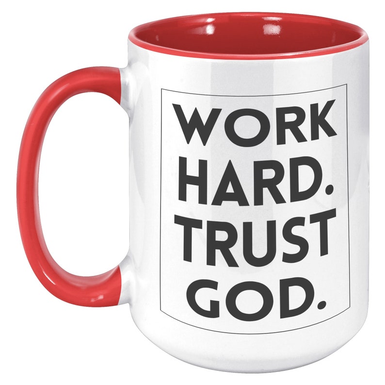 May include: White ceramic mug with a red interior and handle. The mug features the text "WORK HARD. TRUST GOD." in bold black letters inside a black rectangle. The mug is designed for hot beverages.