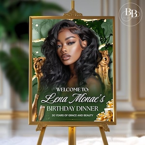 May include: A gold-framed sign on a gold easel. The sign features a portrait of a woman with dark hair and the text "Welcome to: Lena Monae's Birthday Dinner, 30 Years of Grace and Beauty."