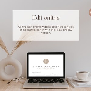 May include: A laptop computer displaying a facial treatment contract template on the screen. The template has a logo with a stylized plant design and the text "FACIAL TREATMENT". The laptop is on a wooden table with a vase of dried pampas grass, a pair of glasses, and a stack of white papers with a coffee cup on top.