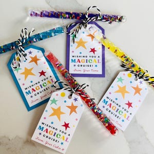 May include: Several colorful wand-shaped party favors with tags. The wands are filled with glitter and confetti. The tags say "Wishing You a Magical Cruise!" with star graphics. The tags are tied with black and white twine.