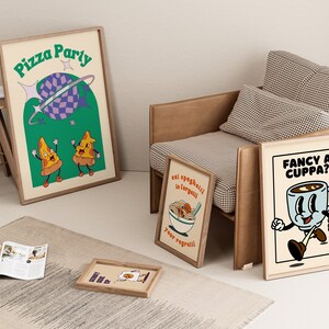 May include: Several framed art prints with retro-style illustrations. One print says "Pizza Party" with pizza slice characters. Another says "Fancy a Cuppa?" with a coffee cup character. A third print says "eat spaghetti to forgetti your regretti".