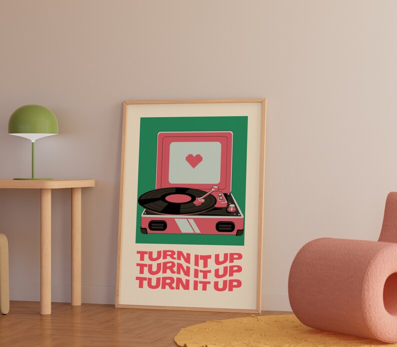 May include: A pink record player with a heart on the speaker and the text "TURN IT UP" repeated three times. The record player is on a green background.