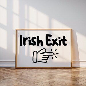 May include: A white framed sign with black text that reads "Irish Exit" and a black and white cartoon hand pointing to the right.
