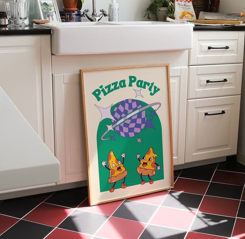 May include: A framed poster with the words "Pizza Party" in green, featuring cartoon pizza slices and a checkered planet. The poster has a light wood frame and is set against a kitchen backdrop.