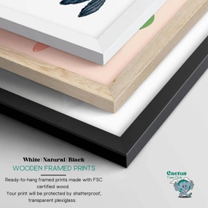 May include: Three wooden picture frames in white, natural wood, and black. The frames are stacked on top of each other, with the white frame on top. The text "White | Natural | Black WOODEN FRAMED PRINTS" is visible at the bottom of the image. The text "Ready-to-hang framed prints made with FSC certified wood. Your print will be protected by shatterproof, transparent plexiglass." is also visible. The text "Cactus Tree Club" is visible in the bottom right corner of the image.